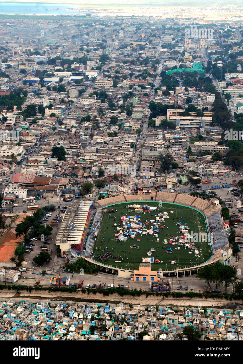 Aerial view refugee tents in a soccer stadium amid destroyed buildings in the aftermath of a 7.0 magnitude earthquake that killed 220,000 people January 18, 2010 in Port-au-Prince, Haiti. Stock Photo