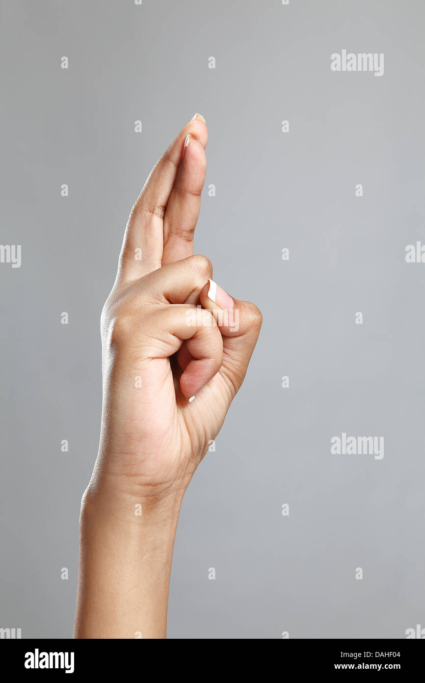 Woman's hand with crossed fingers Stock Photo - Alamy