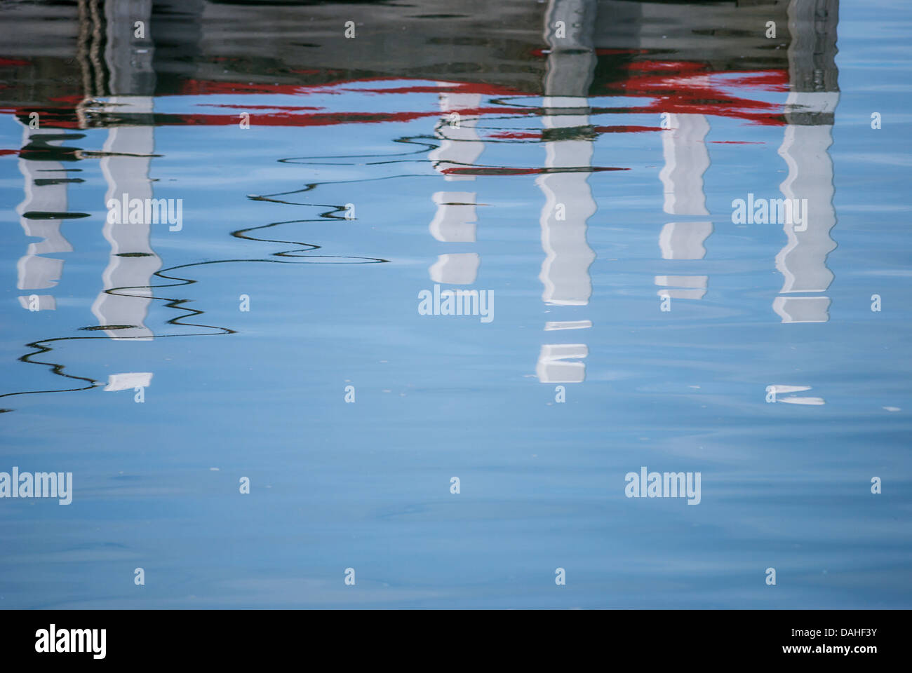 Abstract images of reflections of a boat marina in the rippling water of a harbour. Stock Photo