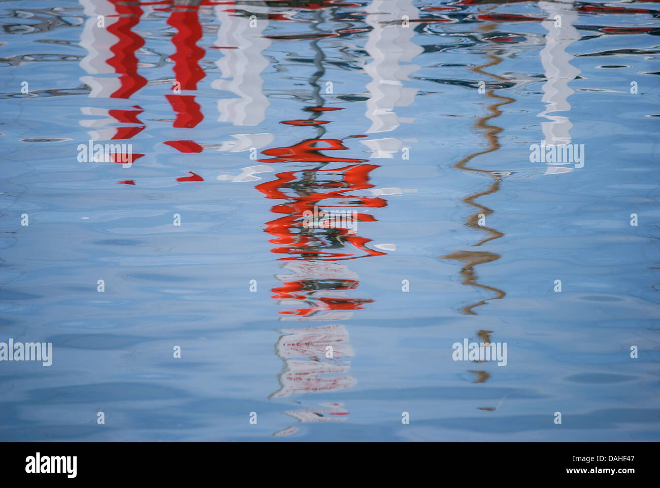 Abstract images of reflections of a boat marina in the rippling water of a harbour. Stock Photo