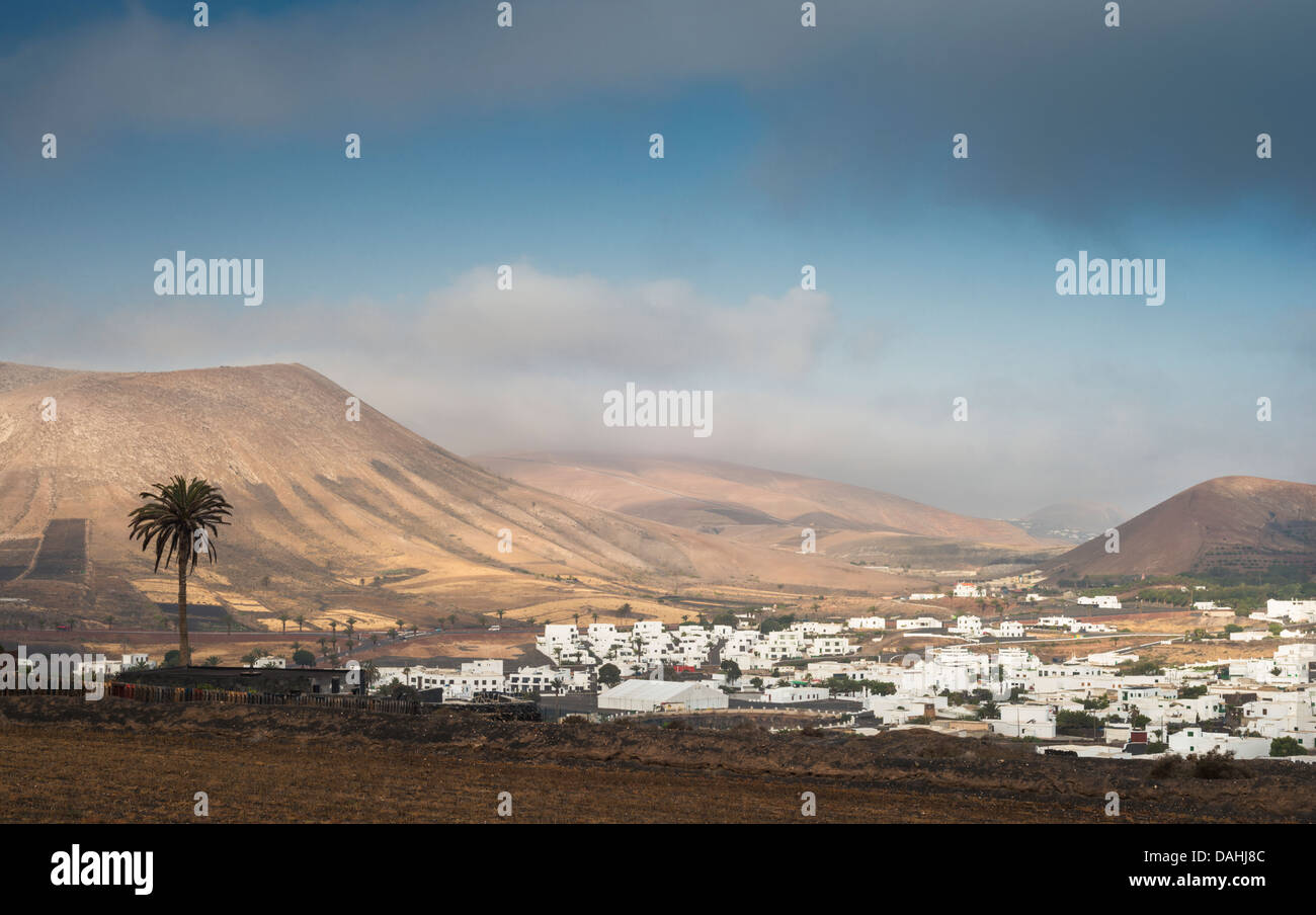 Early morning at the village of Uga, Lanzarote, Canary Islands, with the deeply weathered Ajaches Mountains in the background Stock Photo