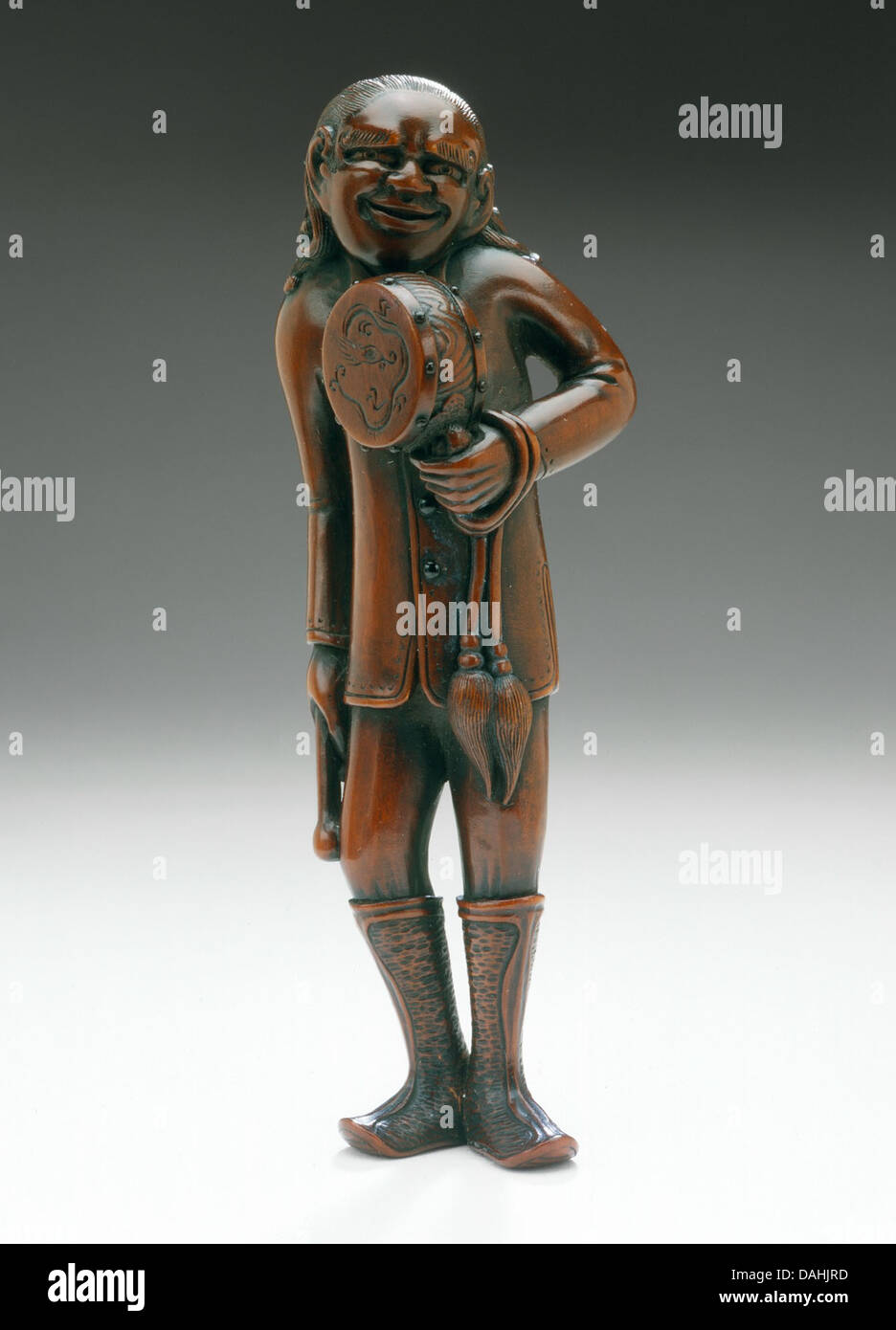 This sculpture represents a foreign drum master, highlighting the role of music and ritual in ancient cultures. The figure’s detailed craftsmanship portrays the musician’s importance in society. Stock Photo