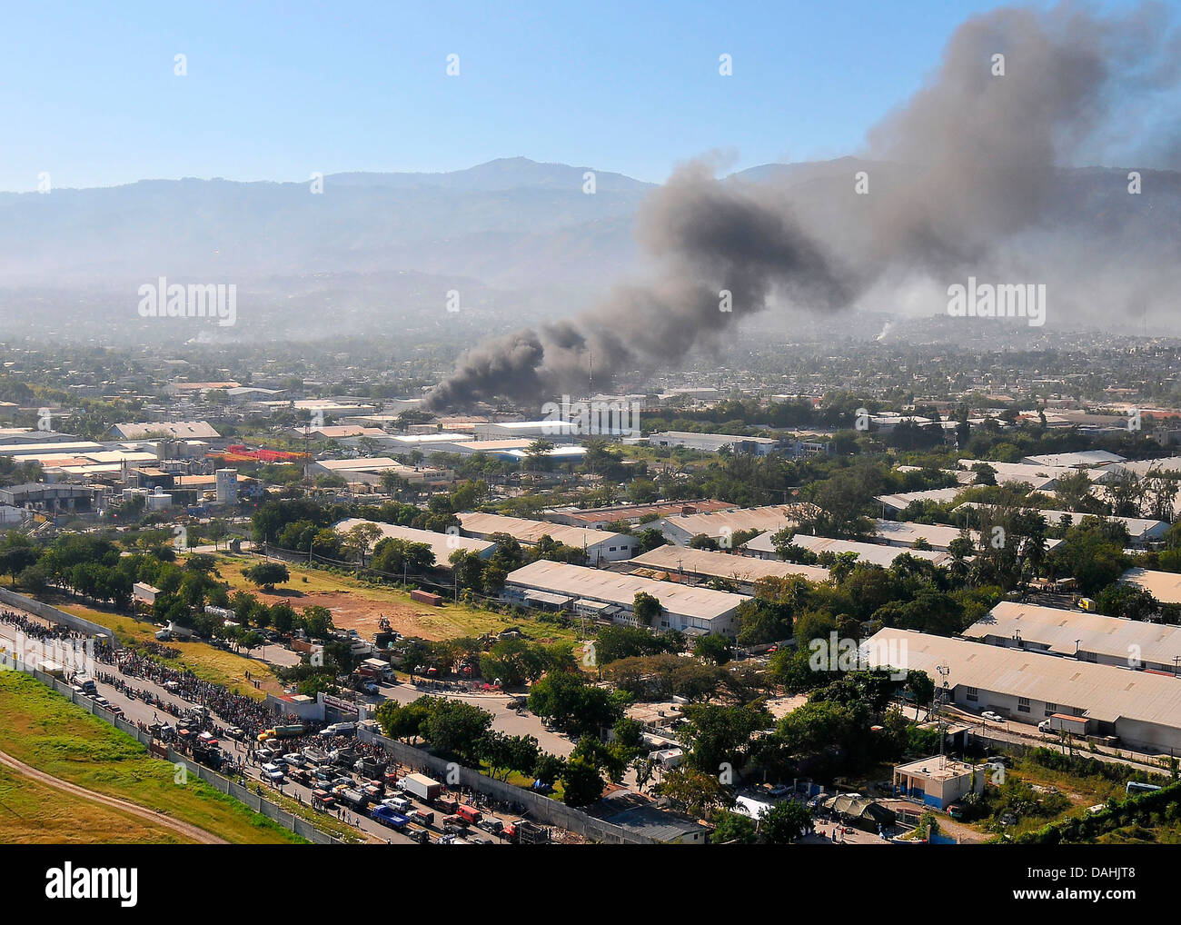Aerial view of fire in the ruins in the aftermath of a 7.0 magnitude earthquake that killed 220,000 people January 18, 2010 in Port-au-Prince, Haiti. Stock Photo