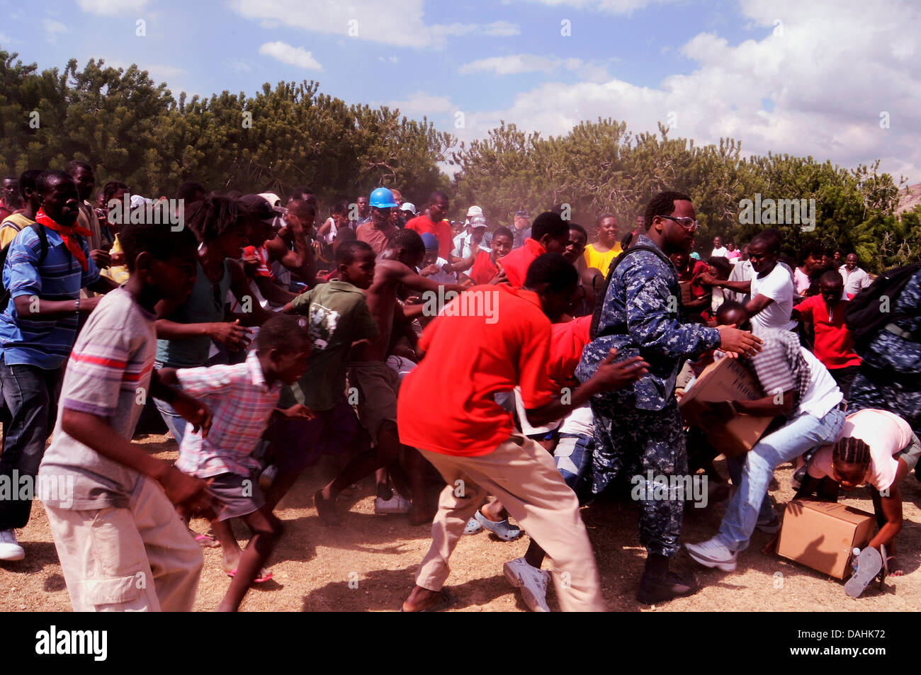 Haitians jostle for food rations at a US Navy aid distribution center in the aftermath of the 7.0 magnitude earthquake that killed 220,000 people February 17, 2010 in Port-au-Prince, Haiti. Stock Photo
