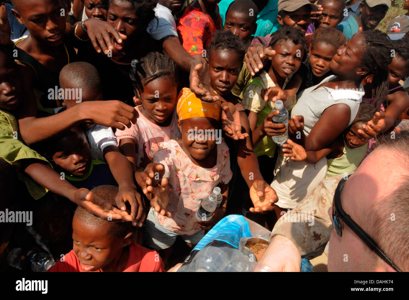 Children jostle for food rations at a US Navy aid distribution center at the Cabaret Baptist Children's Home in the aftermath of the 7.0 magnitude earthquake that killed 220,000 people February 4, 2010 in Cabaret, Haiti. Stock Photo