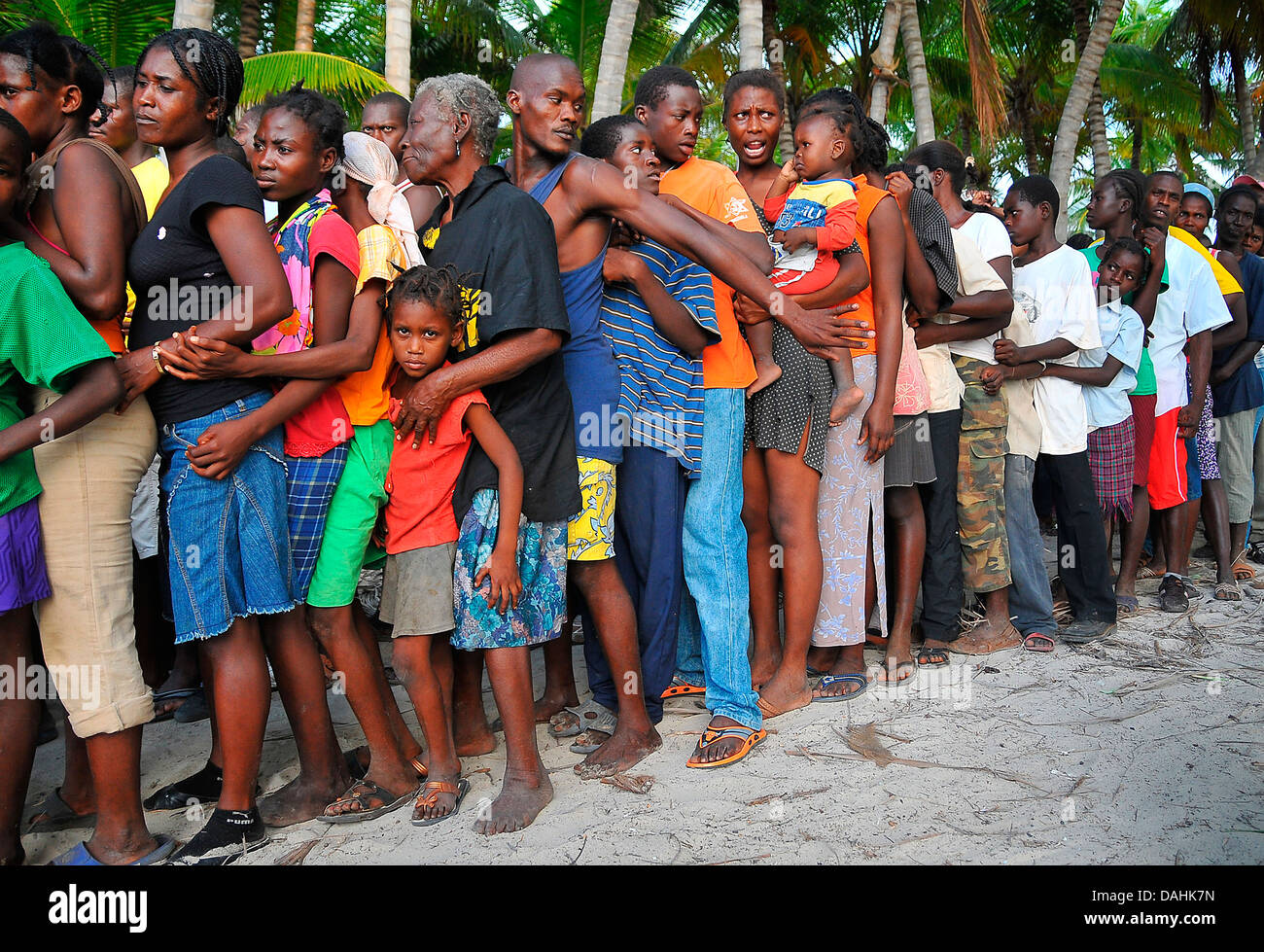 Haitians line up at a US Navy aid distribution center in the aftermath of the 7.0 magnitude earthquake that killed 220,000 people January 27, 2010 in Cerca-la-Source, Haiti. Stock Photo