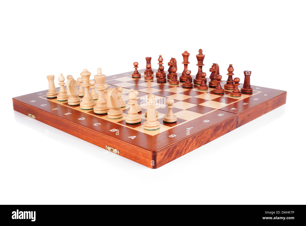 Wooden Chessboard with peaces ready to play on white background Stock Photo