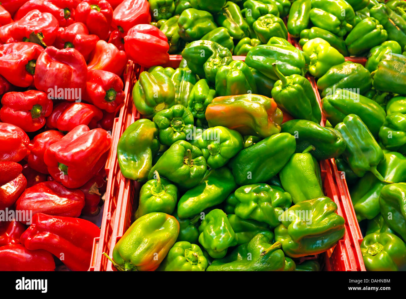 Organic green and red sweet peppers in the supermarket Stock Photo