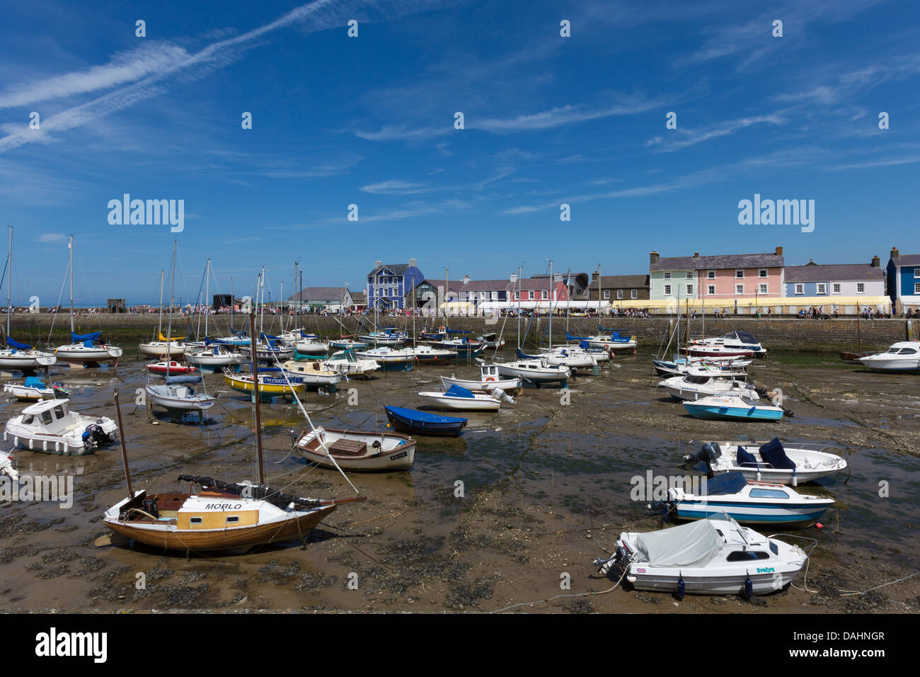 Aberaeron harbour at low tide, during the Cardigan Bay Seafood Festival 2013. Harbourmaster Hotel and pastel painted houses. Stock Photo