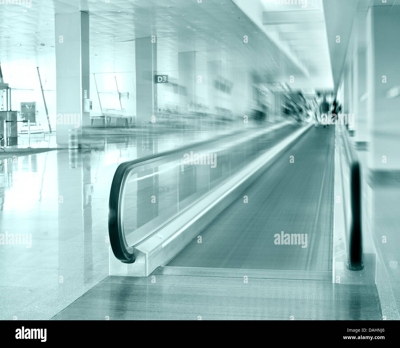 Travel concept. Escalator inside modern airport terminal. Image in blue colors with blur Stock Photo