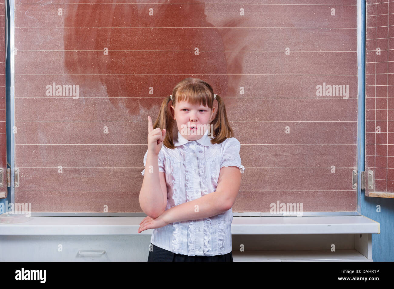 Schoolgirl in a classroom Stock Photo - Alamy