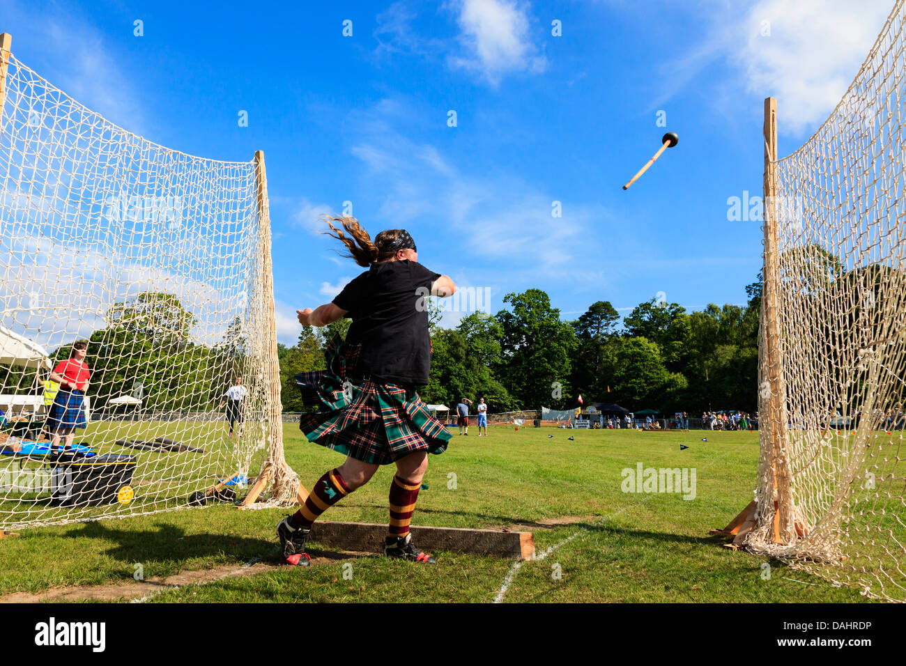 Competitor at Scottish highland games throwing the 22 pound hammer, a traditional Scottish competition. Stock Photo