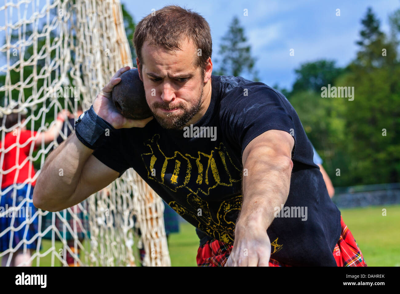 Competitor throwing the 16 pound ball in the traditional Scottish competition at the Highland Games, Stock Photo