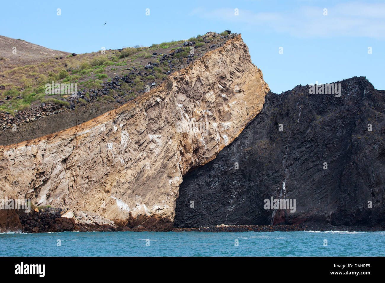 Geological contact between layers - tuff (compacted volcanic ash) on the left and the darker scoria (cinder) formation on a volcano in the Galapagos Stock Photo