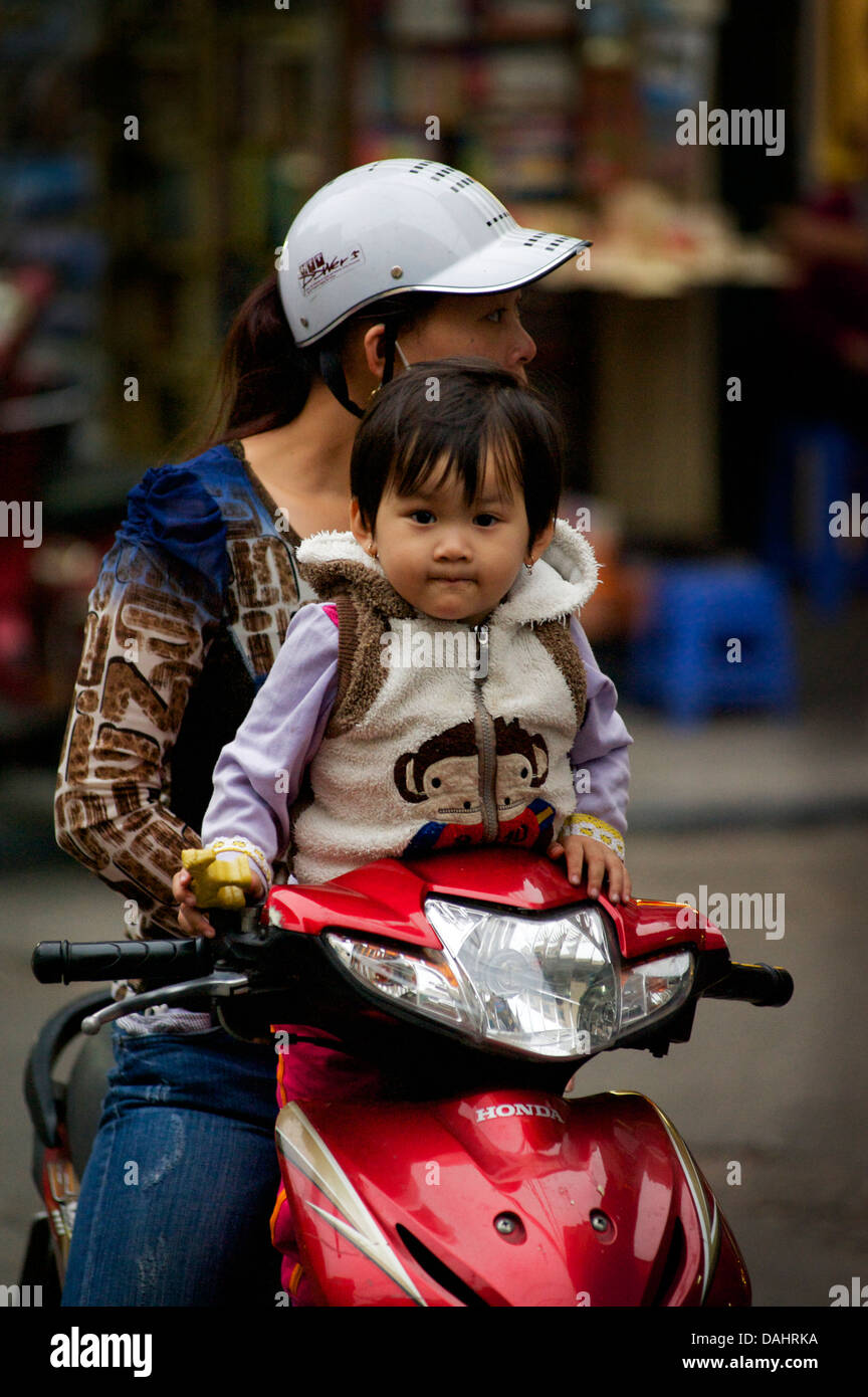 Vietnamese Woman On Motorcycle With Daughter, Old Quarter, Hanoi 