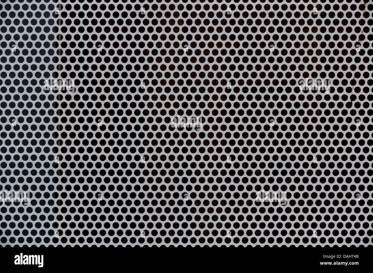 Background of gray metal with perforated holes Stock Photo