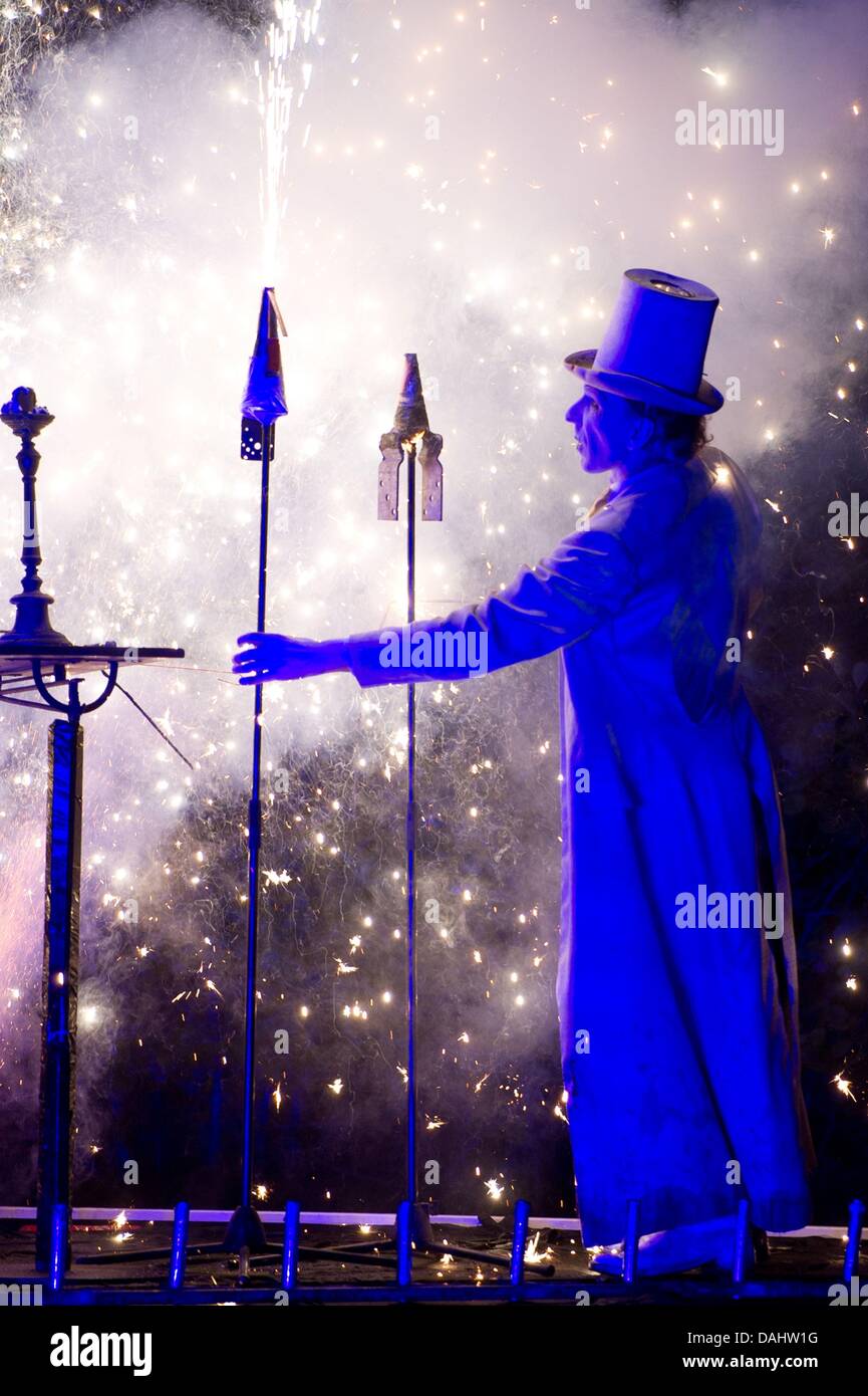 Performer Ton Roeder stands in the middle of a pyrotechnic display ...