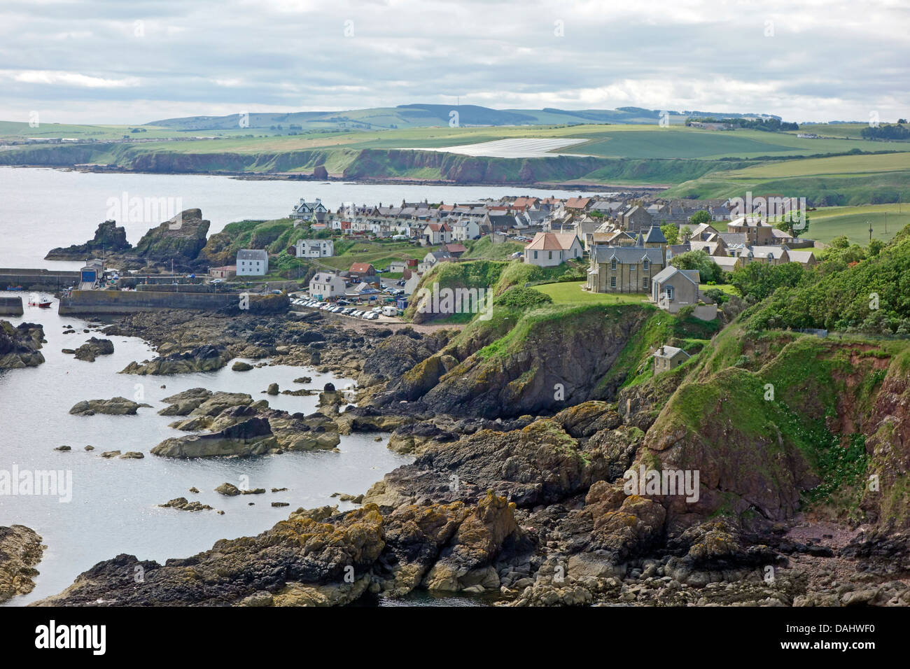 The small fishing village and harbour St. Abbs in East Lothian Scotland seen from across Starney Bay Stock Photo