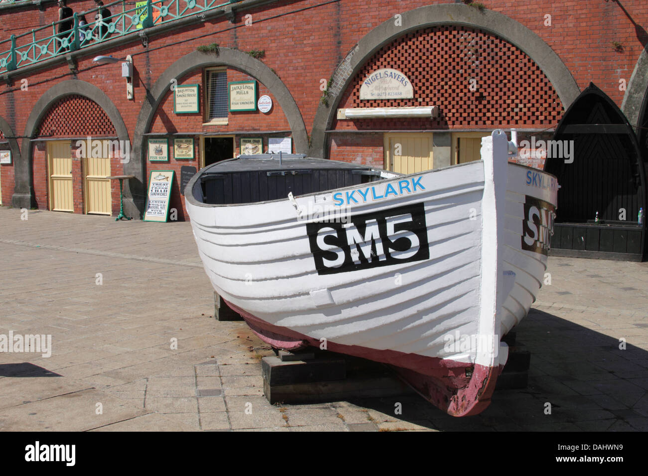 Boat on display by Brighton fishing Museum at the seafront Stock Photo