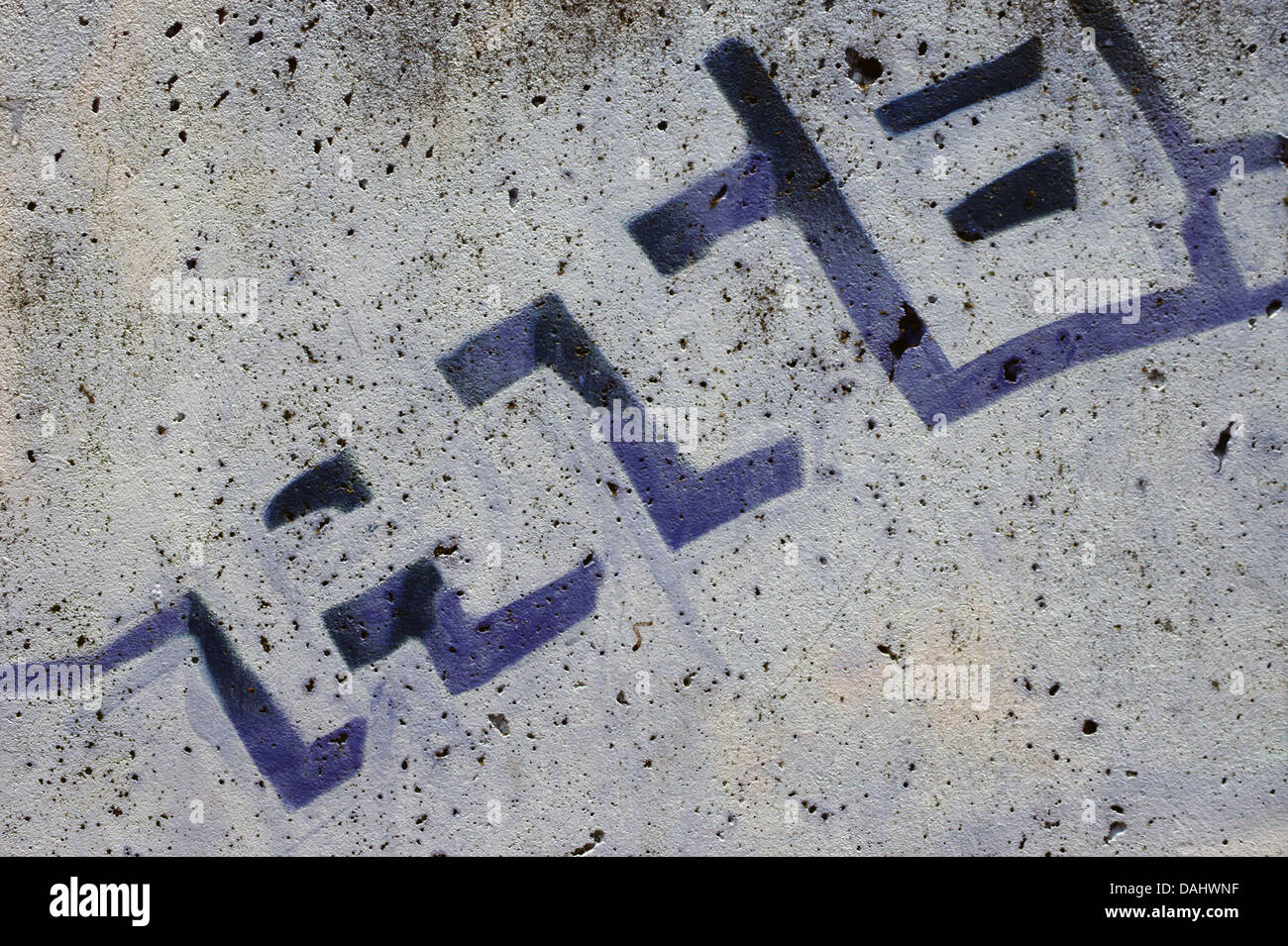 Letters on a porous wall Stock Photo