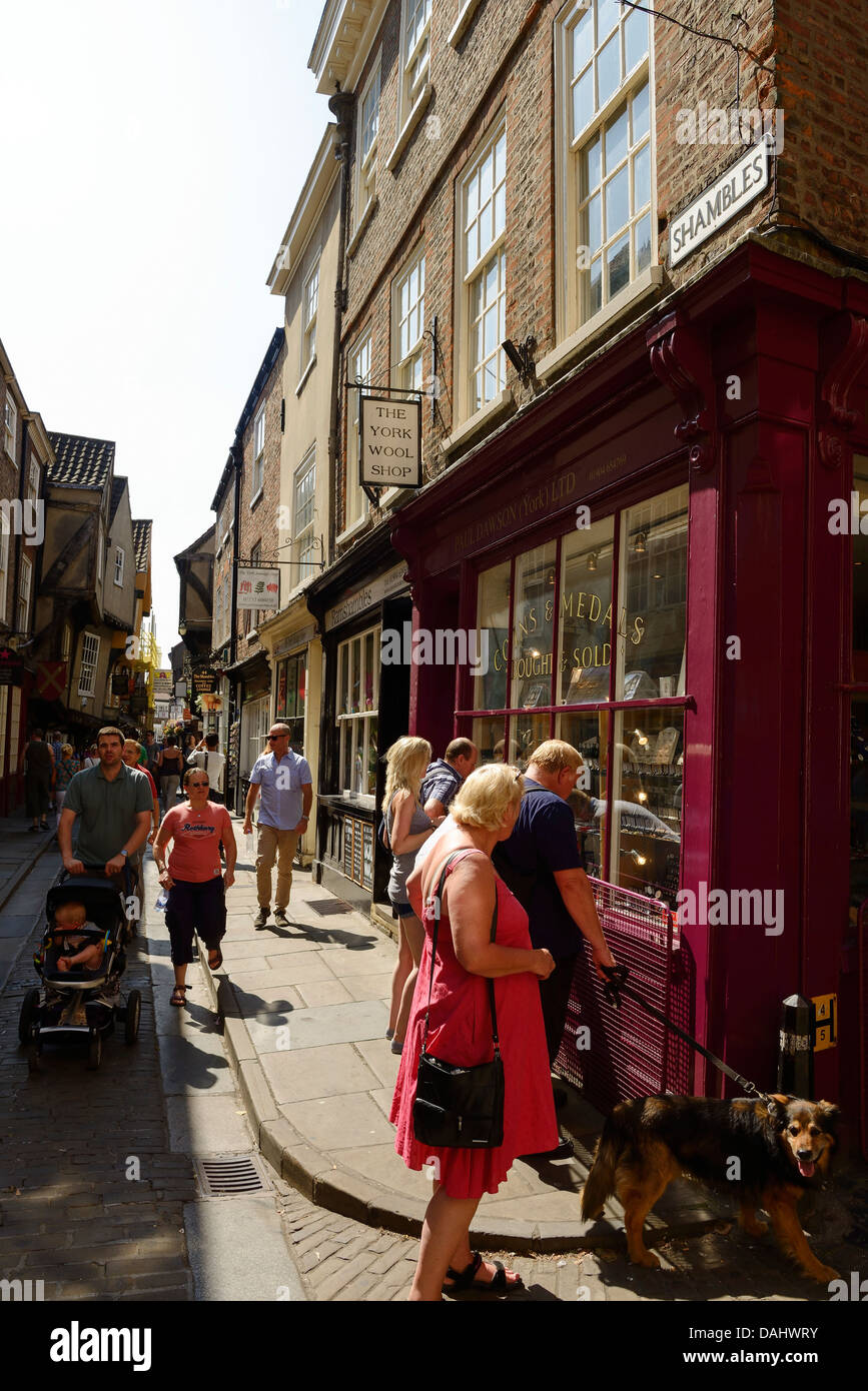 Tourists and shoppers walk along the Shambles in York city centre Stock Photo