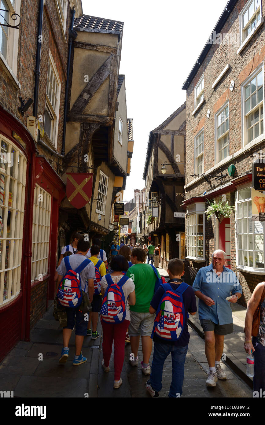 Tourists and shoppers walk along the Shambles in York city centre Stock Photo