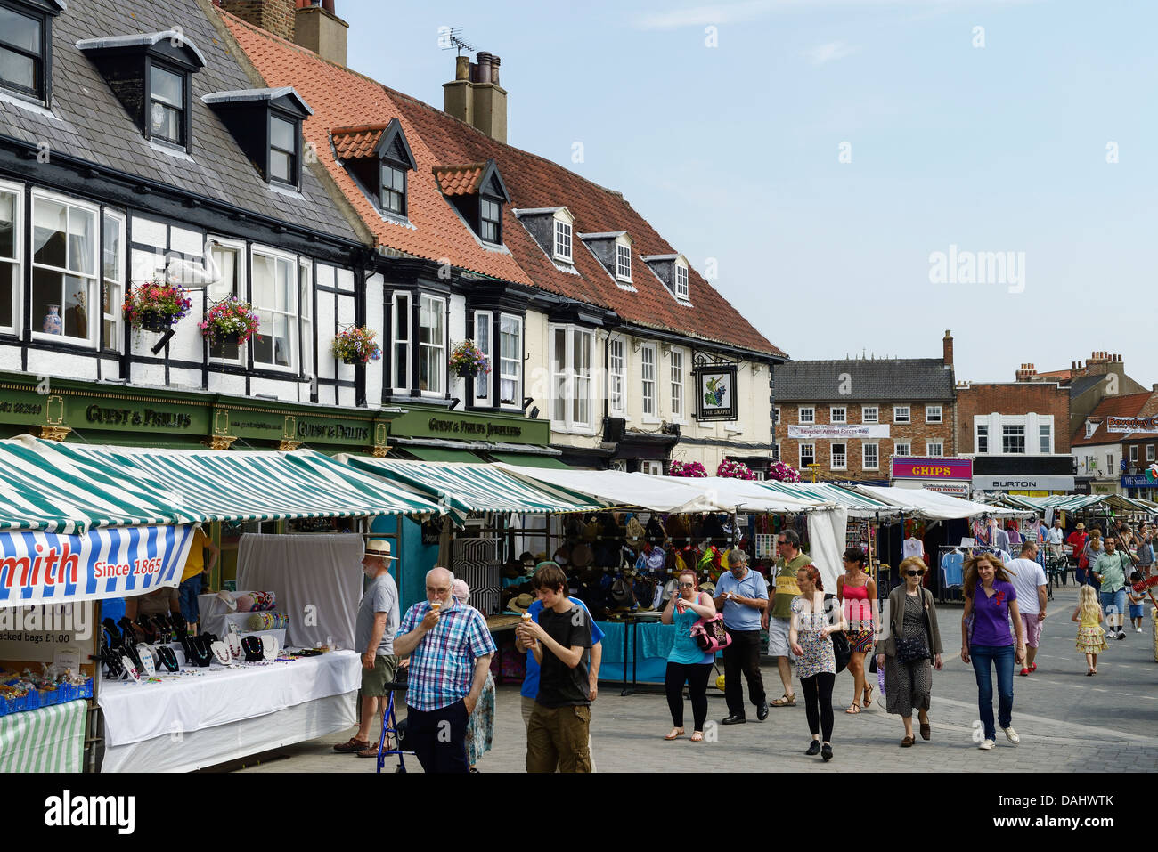 Shoppers browse the market stalls in Beverley town centre UK Stock Photo