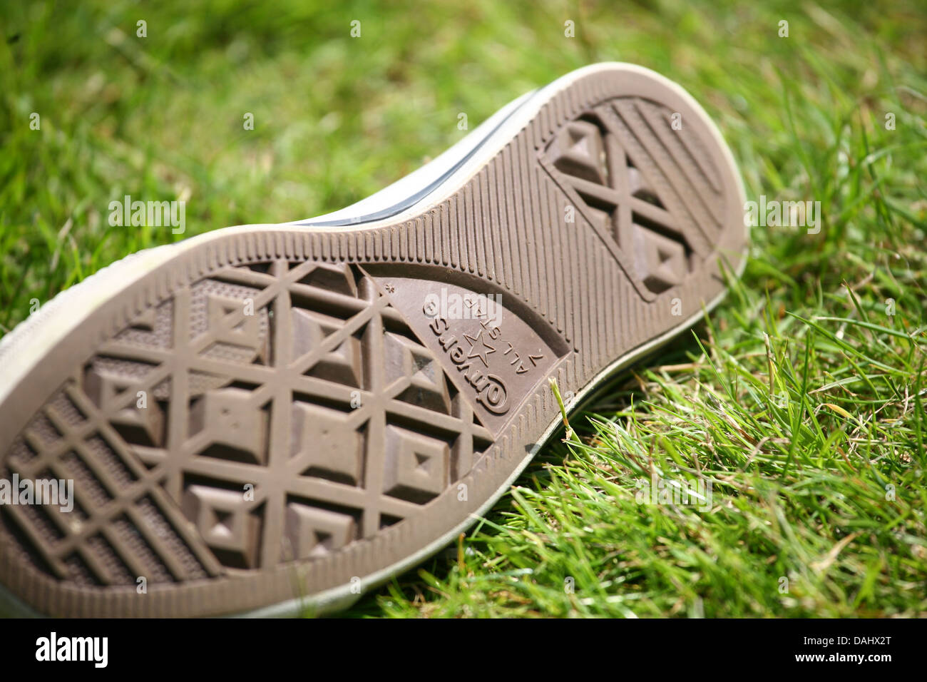 converse training shoe on grass. shallow depth of field. focus on converse  name Stock Photo - Alamy