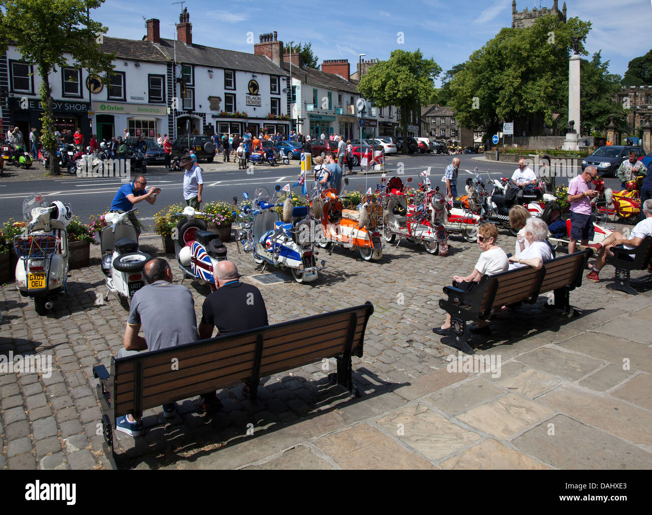 July tourists enjoying the summer weather in the town of Skipton in North Yorkshire. Residents and tourists seated in the summertime sunshine in 2013. Stock Photo