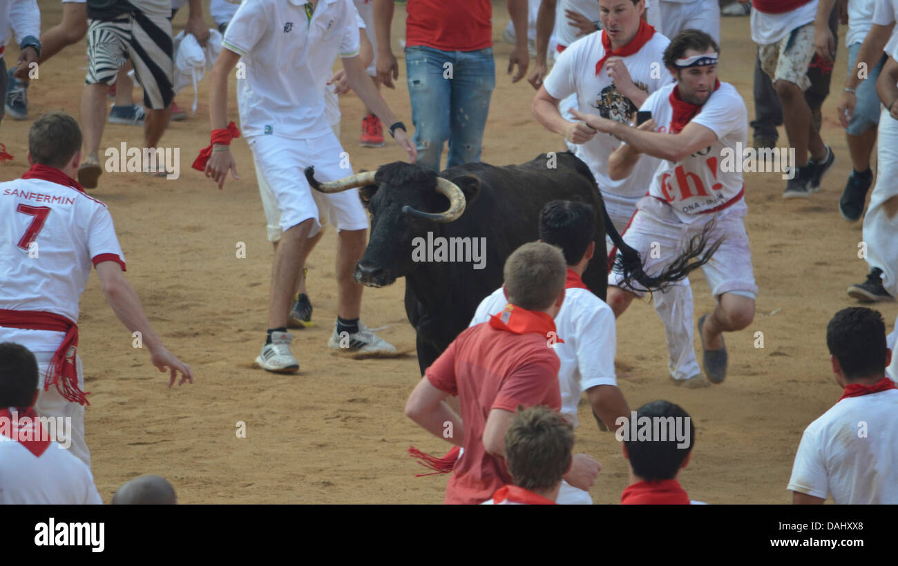 Crowds of people confronting a bull at the annual San Fermin festival in Pamplona, Spain Stock Photo