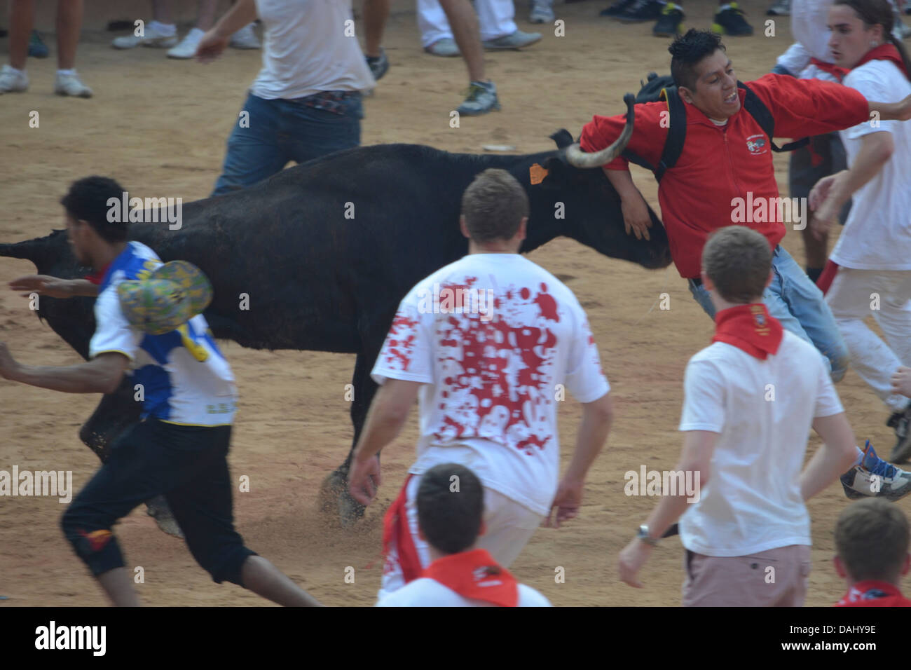 Crowds of people confronting a bull at the annual San Fermin festival in Pamplona, Spain Stock Photo