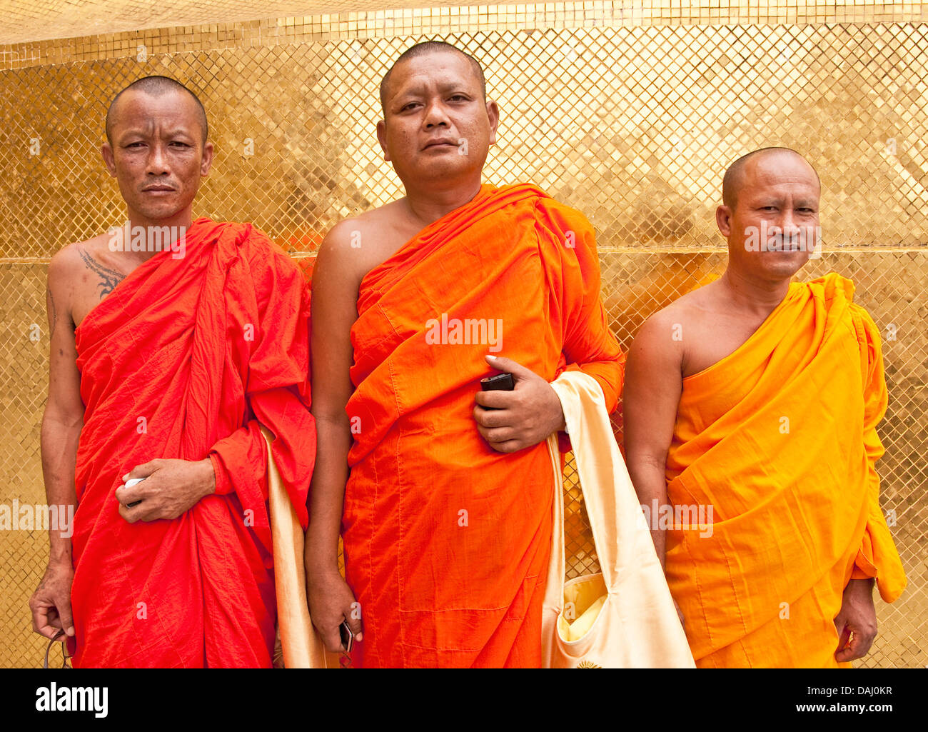 Buddhist monks at Wat Phra Kaew golden chedi in Grand Palace in Bangkok. Stock Photo