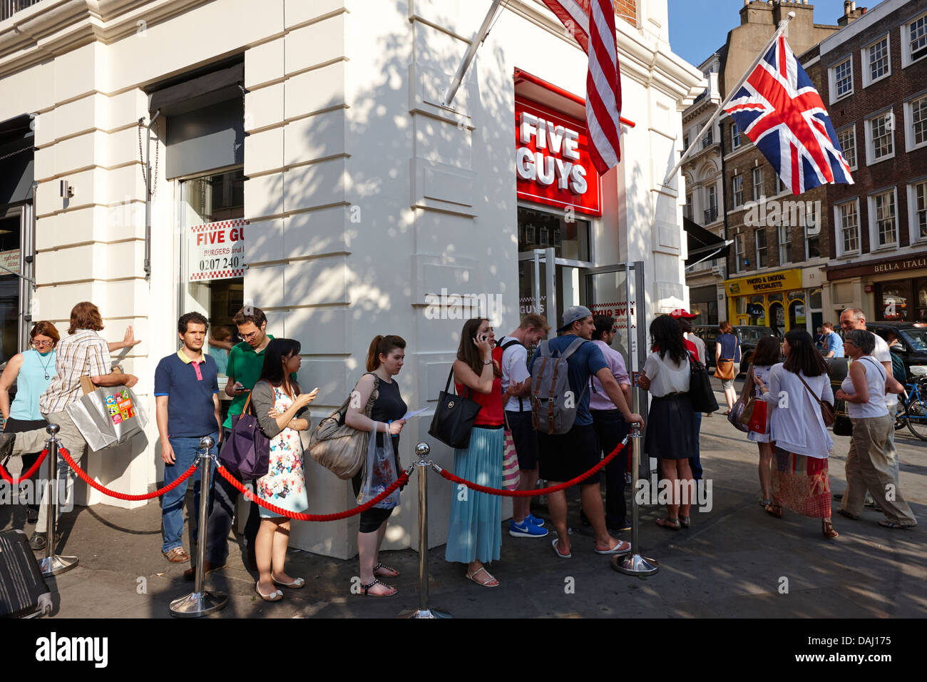 queues outside five guys burger restaurant newly opened in covent garden london, england uk Stock Photo
