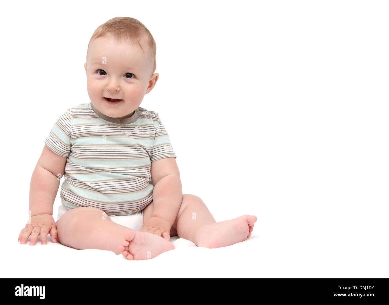 beautiful laughing baby boy sitting on white background Stock Photo