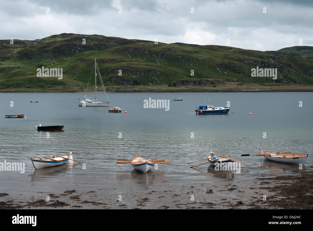 Four Fair Isles St Ayles Skiffs Beached at Tighnabruaich Scotland Stock Photo