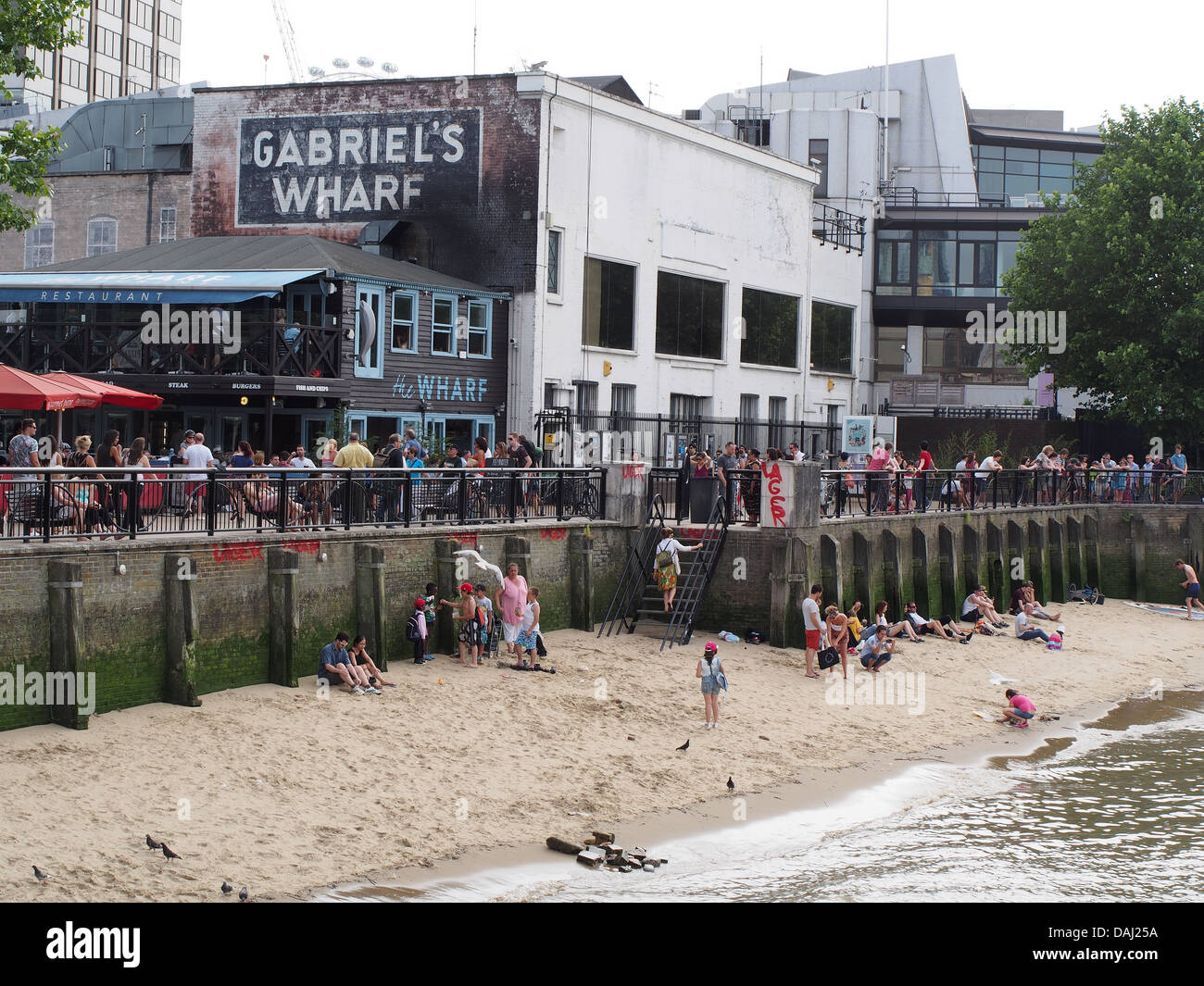 A view of the short stretch of sandy beach by Gabriel's Wharf on the River Thames in London Stock Photo