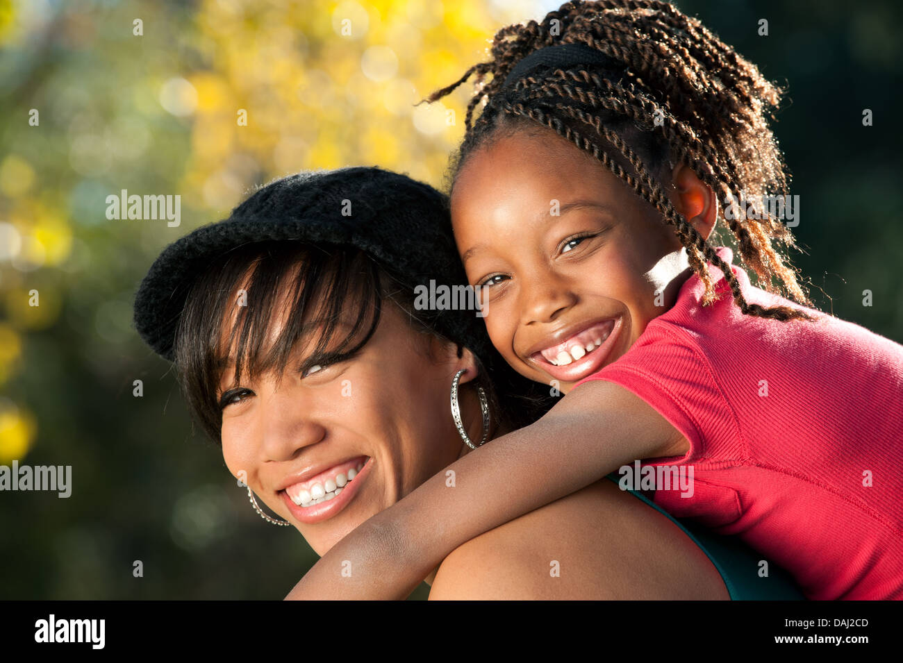 Happy African American mother and child having fun spending time together in a park Stock Photo