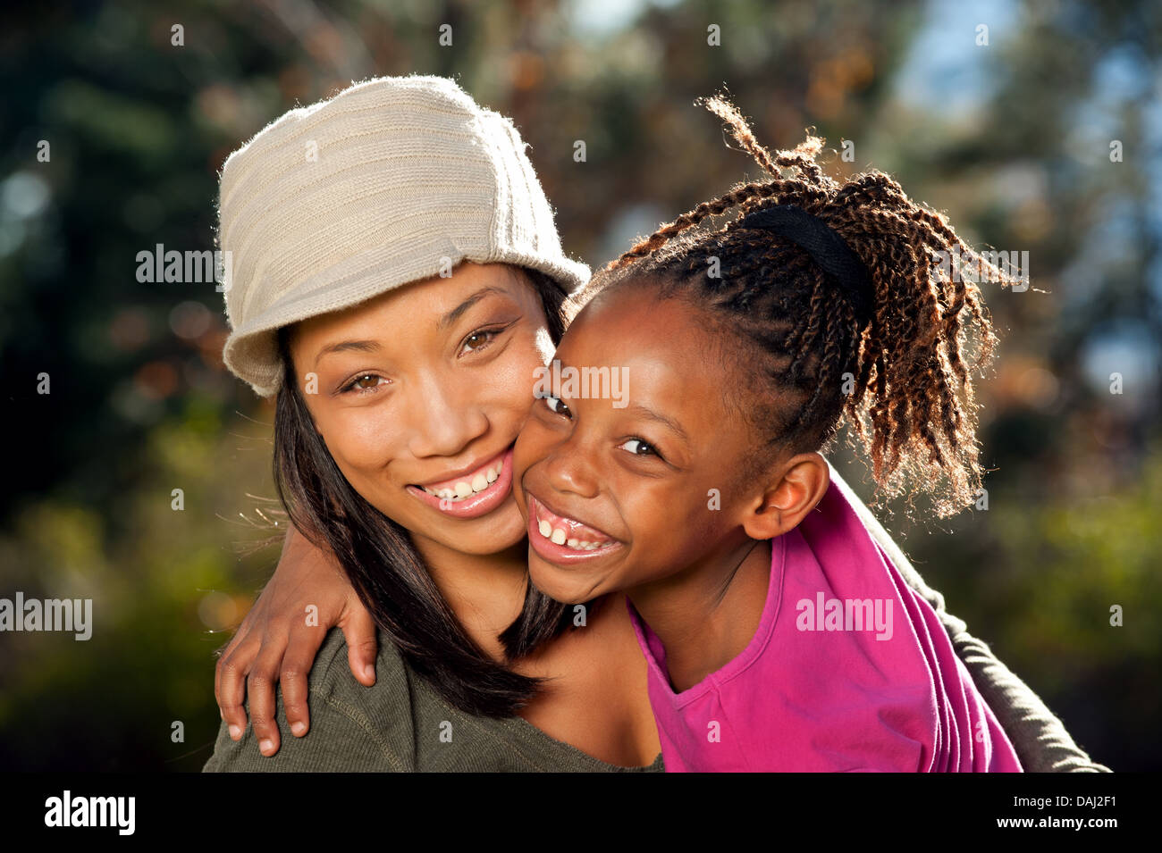 Young African American mother and daughter enjoying nice sunny day in a park. Stock Photo