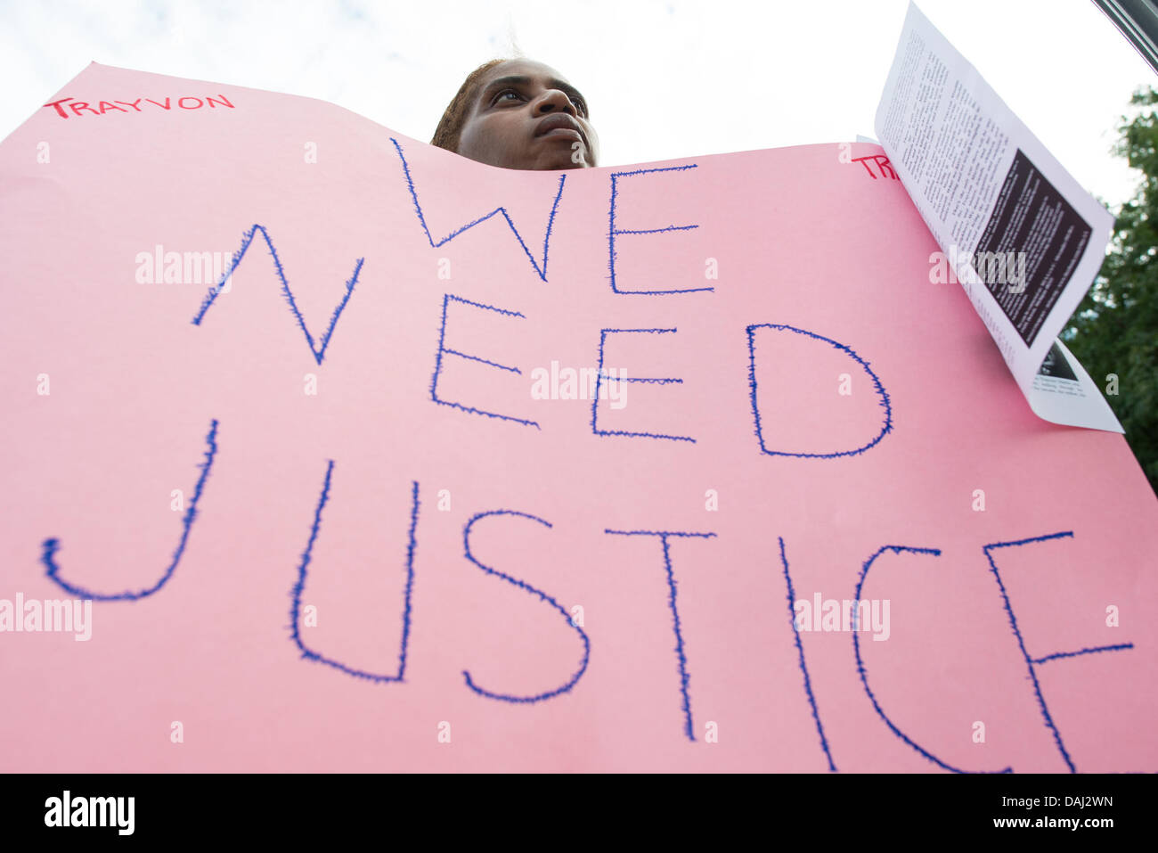 Detroit, MI, USA. 14th July, 2013. A woman holds a sign in Detroit's Grand Circus Park that reads ''We need justice'' during a rally demanding justice for Trayvon Martin the day after George Zimmerman was found not guilty. Credit:  Courtney Sacco/ZUMAPRESS.com/Alamy Live News Stock Photo