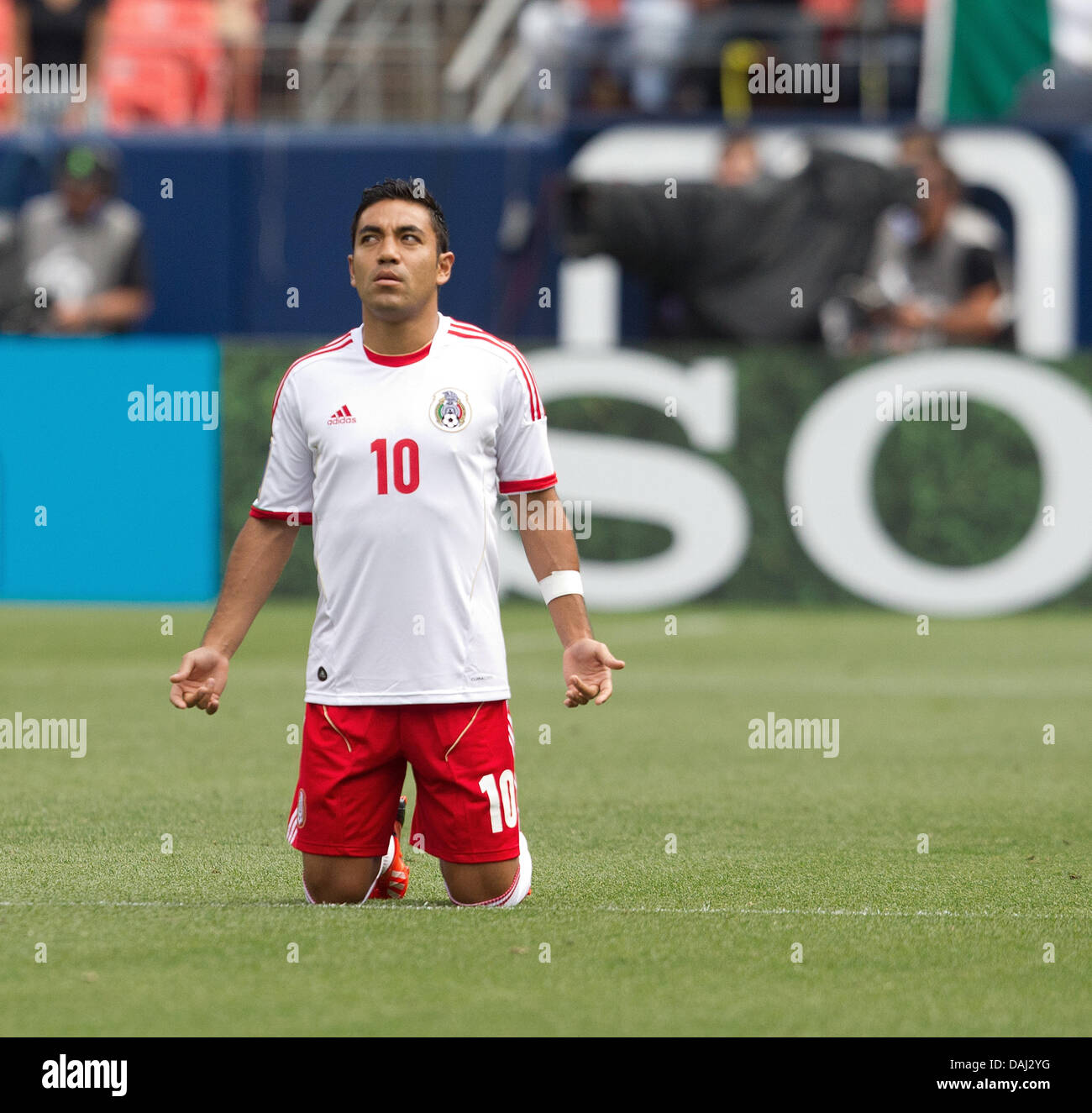 Denver, Colorado, USA. 14th July, 2013. Mexico's MARCO FABIAN kneels to pray before the match between Mexico and Martinique at Sports Authority Field at Mile High Sunday afternoon. Mexico defeats Martinique 3-1. Credit:  Hector Acevedo/ZUMAPRESS.com/Alamy Live News Stock Photo