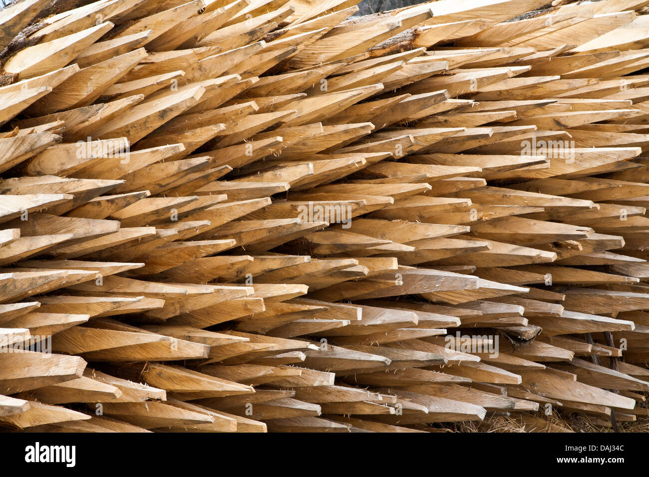 Stacked wooden fence post spikes at a sawmill lumber yard in Vermont