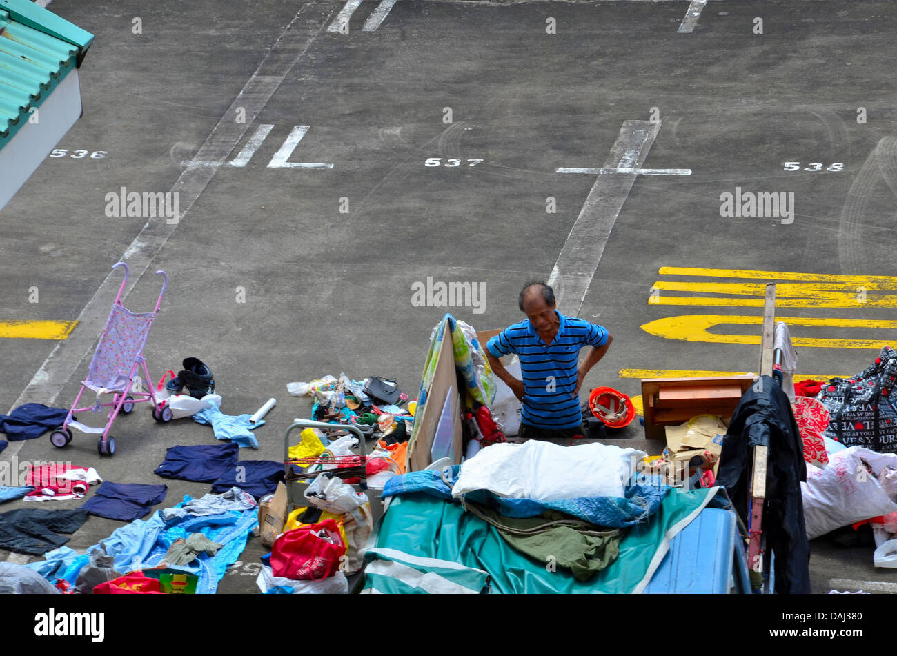 Singapore recycling Karung Guni man grimaces at trash pile Stock Photo