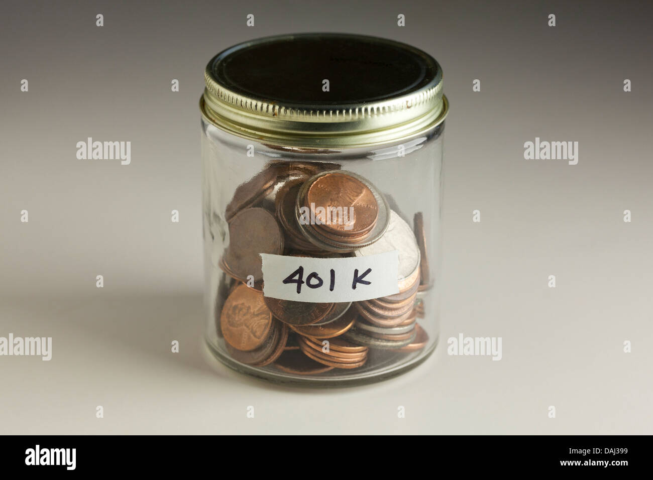 Coins in glass jar for 401k savings Stock Photo