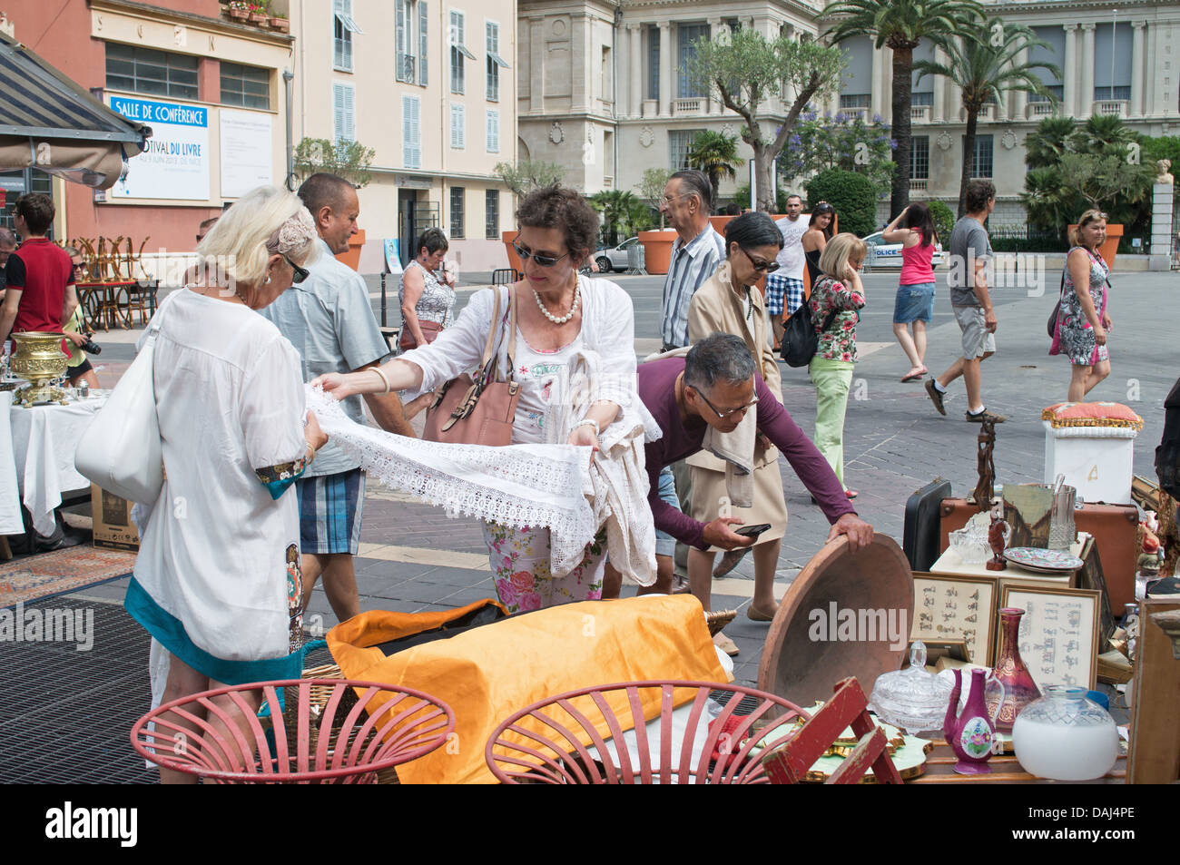 People browsing through goods on a stall at Nice antiques market, France Stock Photo