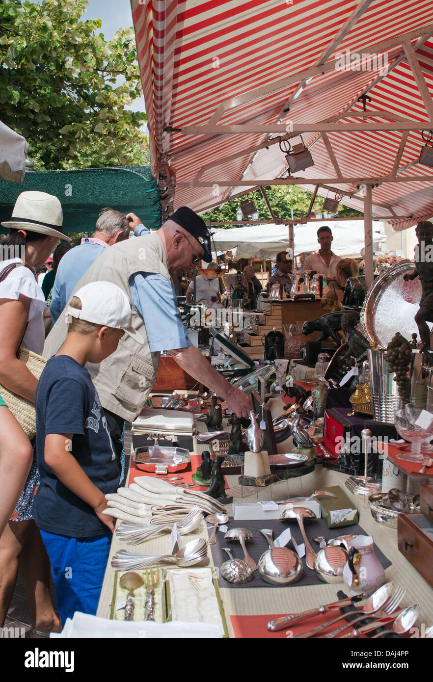 People browsing at a stall within Nice antiques market, France Stock Photo