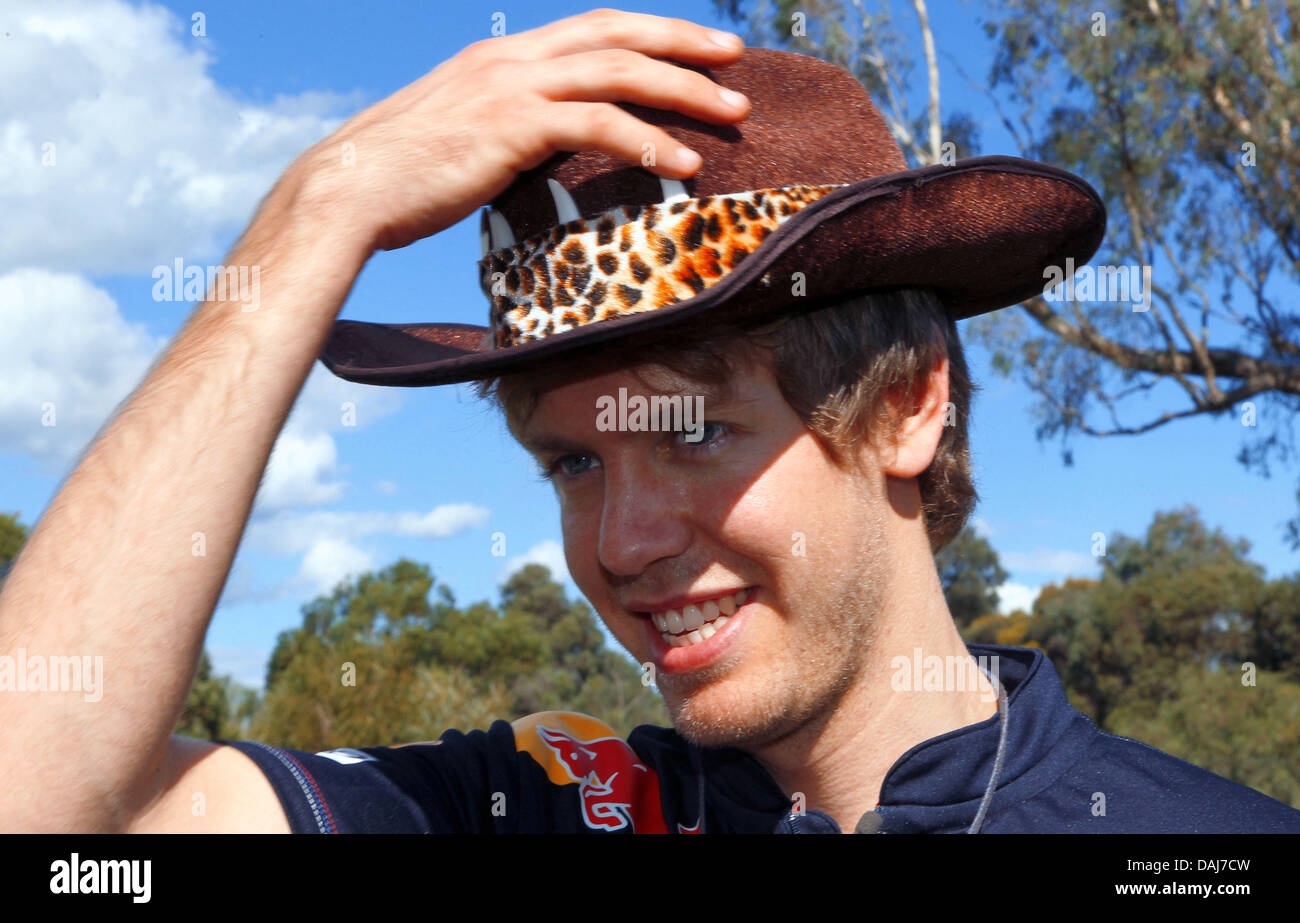 German Formula One driver Sebastian Vettel of Red Bull puts on a hat at a  farm in Monomeith near Melbourne, Australia, 23 March 2011. The Formula One  Grand Prix of Australia takes