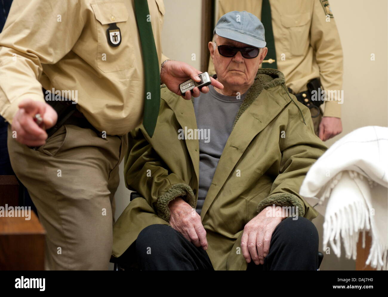 The picture shows John "Iwan" Demjanjuk at the continuation of the trial at the district court in Munich, Germany on 23 March 2011. The former overseer of the NS extermination camp in Sobibor   John Demjanjuk is being charged with assecory to murder. Lawyers of the joint plaintiffs are in agreement that Demjanjuk is responsible for the deaths of members of their clients' families.  Stock Photo