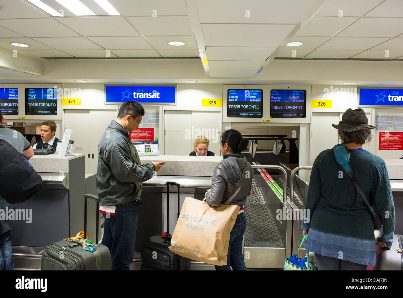 Baggage check-in at the Transat desk, Gatwick Airport Stock Photo - Alamy