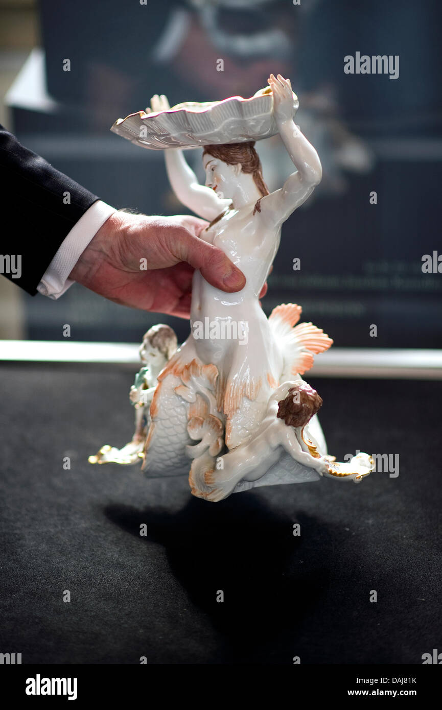 The picture shows the head of the porcelain collection Ulrich Pietsch holding the porcelain sea nymph 'Nereid' which was returned to the Zwinger in Dresden, Germany on 24 March 2011. Present at the ceremonial return were Count Leopold von Brühl, the head of the porcelain collection Ulrich Pietsch and the US-American Embassador in Germany Philip D. Murphy. The porcelain sea nymph 'N Stock Photo