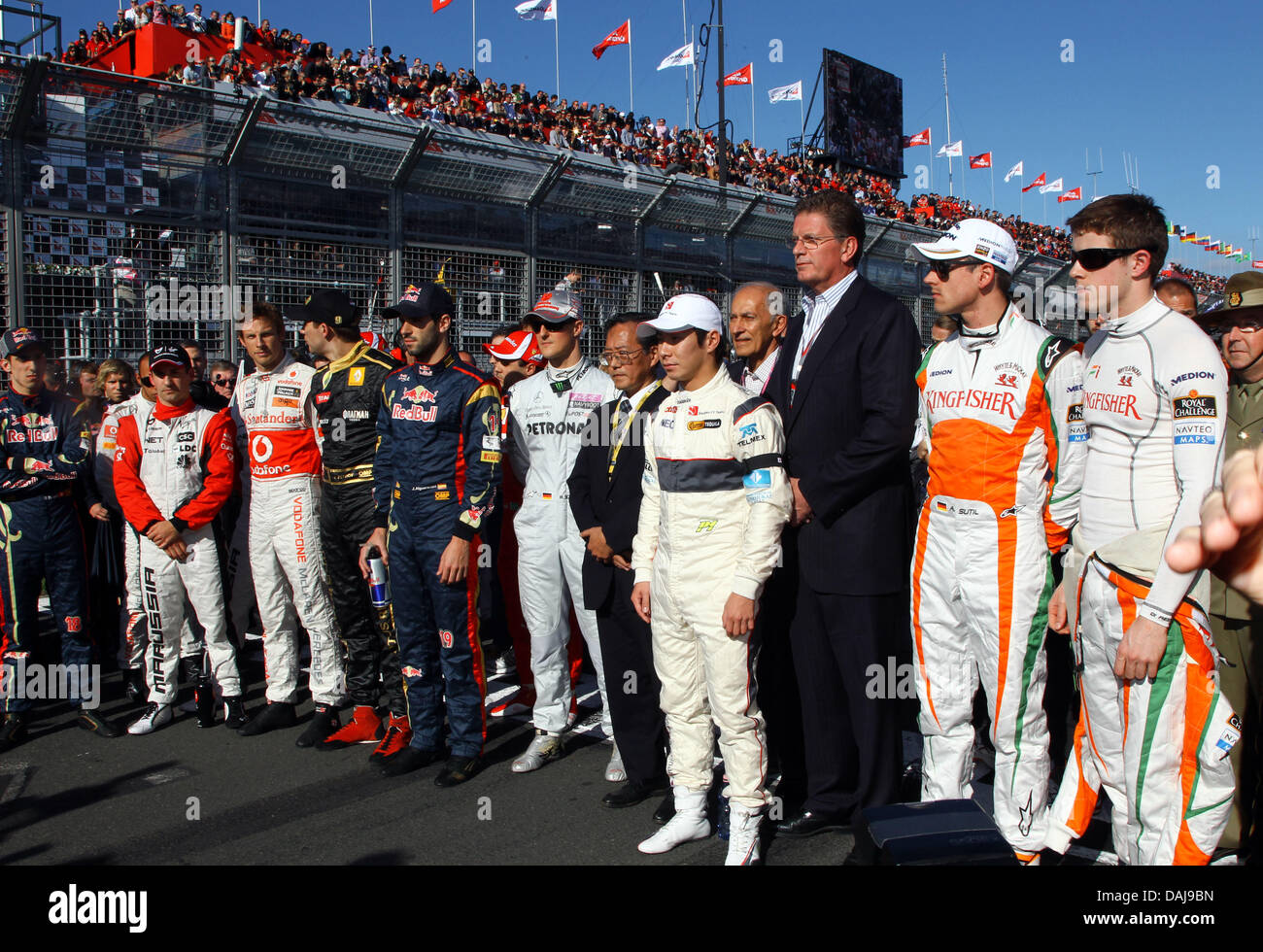 The Picture Shows Formula One Drivers Standing In The Starting Grid